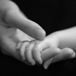 infant-holding-mothers-hand-bw